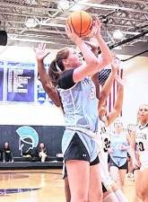 Sparta's Brooke Shust (21) leaps towards the hoop during a shot.