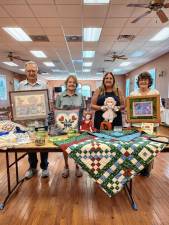 <b>From left, Richard and Barbara Gardiner, Chris Delnero and Barbara Morgan with items for the 78th annual Lord’s Auction on Saturday, Aug. 30. (Photo provided)</b>