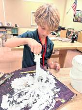 Colby Wood, a third grader, works on an art project.