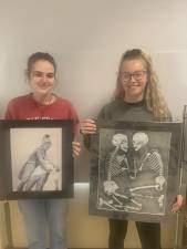 Sophie Lavin and Sarah Coscia hold their entries in the first Historical Art Show at Sussex County Technical School. (Photo provided)