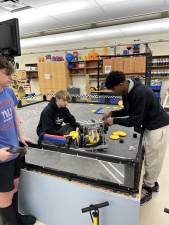 From left are members of Sparta High School robotics team 5249 Z “Artemis”: Nick Audino, who is driving the robot; Liam Askin, the engineer; and team captain Millen Duberry. (Photos by Carlos Davidson)