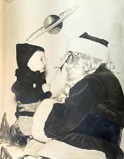 Bill Truran sits on Santa’s lap at Sears in Newton in 1951.
