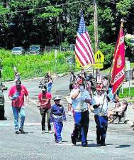 <b>The color guard marches with the flag.</b>