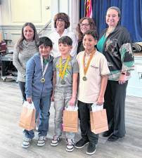 From left, back, Lenore Davis, Maureen Dugan, Kelly Kiff, Andrea Diamond; front, Rohan Sharma, Lucas Jaffe, and Matthew Herasme.