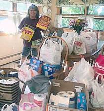 Linda Fuehrer, program chairperson of the Vernon Township Woman’s Club, displays more than $1,000 worth of groceries that the club collected in just one week recently for the food pantry at Family Promise of Sussex County. (Photo provided)