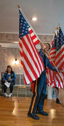 FL2 Patrolman Matt Cannarozzi places an American flag.