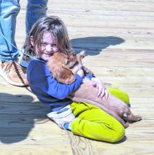 Abigail Ryan holds a dog, Cooper.