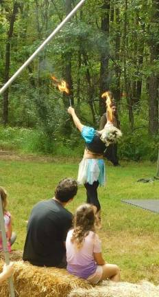 A fire-eating faery performs