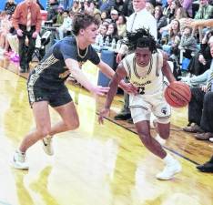 Sparta's Leshem Little handles the ball while covered by Pope John's Tyler Rossi. Little scored 23 points.