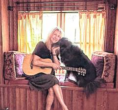 <b>Deb D’Anne and her rescue Scooter in her Middleville studio</b>