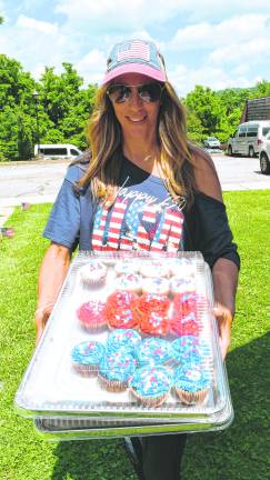 Joani Diana holds cupcakes.