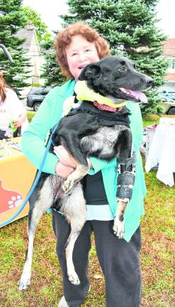 Debbie Kowalchuk holds Allie, a dog available for adoption from One Step Closer Animal Rescue.