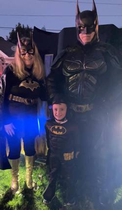 HH3 David Rafailov, 4, poses with Batman and Batwoman.