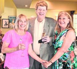 Nancy porter is shown with Randy Burke, owner of Burke’s Liquor Store, and Marjy Murphy, public relations person for Sparta Food Pantry.