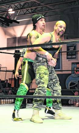 Two wrestlers perform.