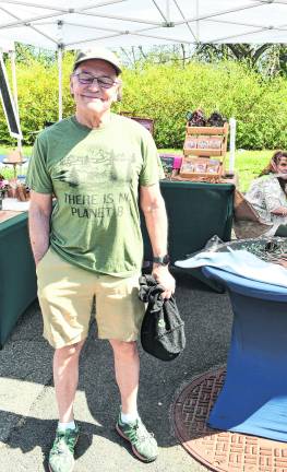 Neil Sauerwein of Sparta stands in front of a table.