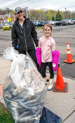 Lauren and Lexie Myhren with a bag of trash they collected. They picked up 32 pounds of trash during the cleanup.
