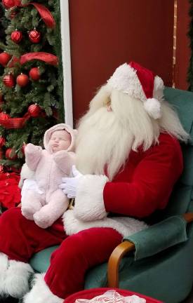 Santa holds 1-month-old Allena Crowell of Newton.