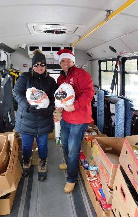 County Director of Social Services Joan Bruseo and WSUS DJ Steve Allan show off turkeys collected at First Hope Bank in Andover on the first day of Stuff the Bus 2018, Friday, Nov. 16, 2018. 