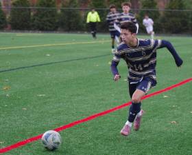 Pope John's Ethan Nowak pursues the ball.