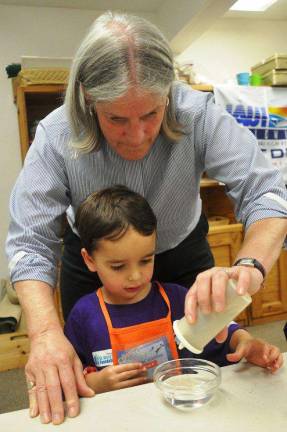 Reverend Carol Gadsden assists in a floating pepper experiment
