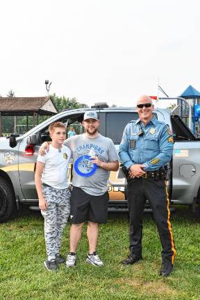 Conner Trossman and Bill Gusta of Vernon pose with Hardyston police Sgt. Alan Carbery at National Night Out in Franklin.