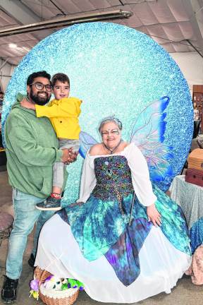 <b>Luis and Theodore Ruiz of Hamburg pose for a photo with a fairy.</b>