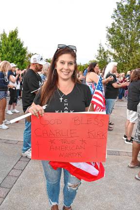 April Matera-Patiro of Rockaway holds a sign at the vigil.