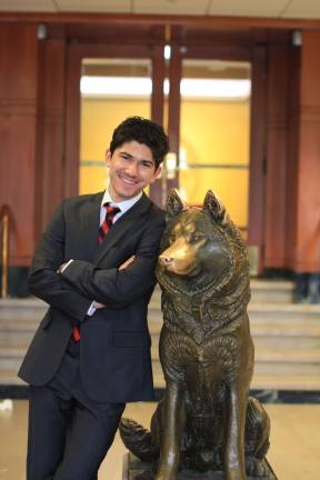 Michael Janov next to Northeastern's mascot &quot;Paws&quot; Photo by Jack Gilbert