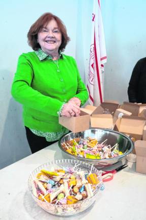 Suzanne Belvedere fills bowls with candy.