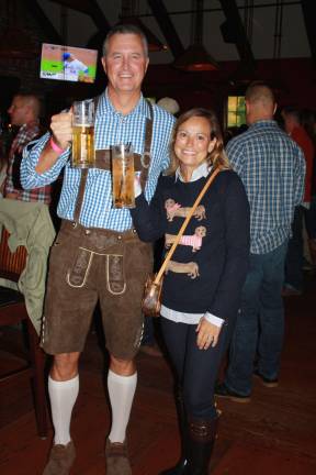 Donning festive Lederhosen attire is Andy Flint with his wife Julie Flint.