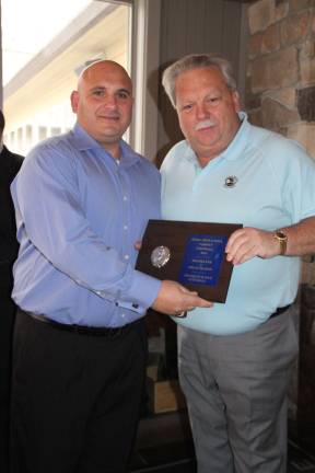 Eric Nielsen presenting an award to Frank Marchiano, SHS Football Head Coach.