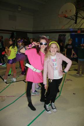 Kiernan Moore and Caitlin Snellings go with a pink theme for 80's Night.