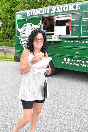 Maryjane Gangemi of Roxbury samples items from one of the 15 food trucks.