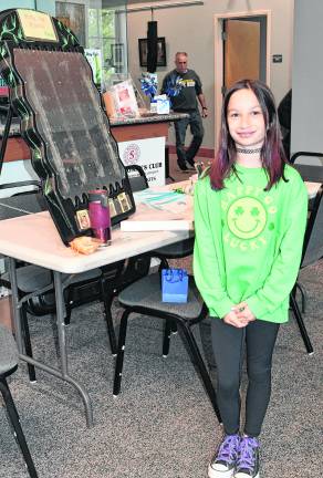 Gabby Keenan of Sparta poses in front of her exhibit.