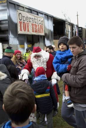 Santa greets children upon his arrival at the Toys for Tots event held at the Sparta Train Station. (Photo by Nancy Madacsi).