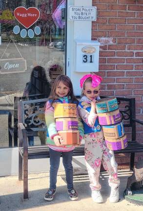 Members of Girl Scouts Daisy Troop 98809 in Sparta hold scratch pads created from empty cookie cases.