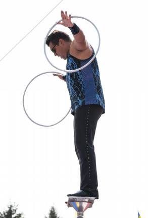 Acrobat Simon Arestov of Circus Incredible performs a balancing act during the show. He is married to his circus partner Lyric Wallenda. (Photo by John Hester)