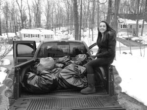 Emma Dodson with the 280 pairs of jeans she collected.