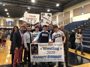 Garrett Steward this weekend broke the Sparta High School win-record, with 127 wrestling wins. Pictured is Garret surrounded by his family, coaches and friends after his 127th win.