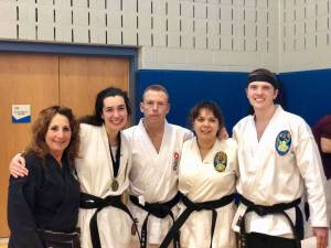Promoted students celebrate after the spring shiai. From left: Barbara Malaro, Jillian Grassia, Sensei Scott Klinger, Katelyn Nieuzytek, and Kyle Allen