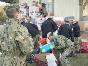 Donated toys are loaded onto the Toys for Tots train at the Sparta station in December 2022. (File photo by Kathy Shwiff)