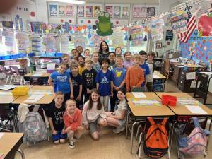 Judith Slavin poses with her students in her second-grade classroom at Alpine Elementary School in Sparta. (Photo provided)