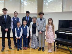 Kanna Pasunuri, at right in back row, poses with his piano students after their recital June 17. At center in front row is his teacher, Beverly Floorman. (Photo provided)