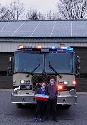 Conner and Nathan drop off 16 masks they made with their 3-D printer to the Fredon Volunteer Fire Company.