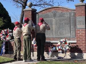 SV1 Members of Boy Scout Troop 95 salute after wreaths are laid at a memorial during the Veterans Day ceremony Saturday, Nov. 11 in Sparta. (Photos provided)