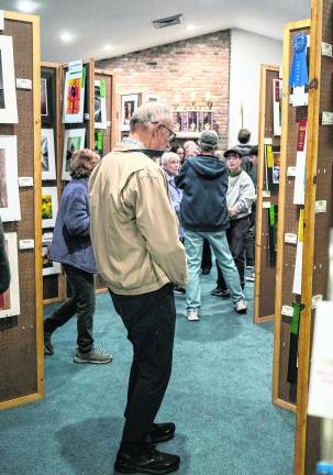 Attendees view the exhibits.