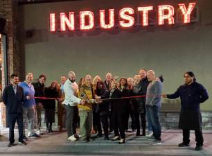 IN1 In center group, from left, chef Carmine DiGiovanni, owners Steve and Rachael Scro, and Sussex County Chamber of Commerce president Tammie Horsfield, surrounded by supporters, cut the wire Nov. 10 to open Industry Restaurant + Bar in Sparta. (Photos provided)