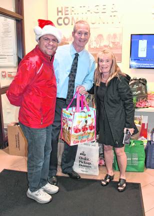 Steve Allan of WSUS is shown taking donations from Sean and Sue Mayer of Lafayette.