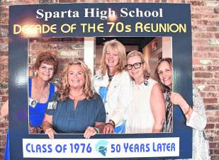 Marie Louise Johnson of Jupiter, Fla., Karen Westbrook of Stillwater, Renee Panten of Sparta, Lisa Lill of Morristown and Kathy Judge of Illinois pose inside a frame.
